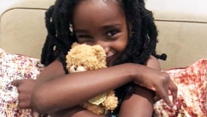 Naomi Pascal holds her teddy bear after they were reunited.
