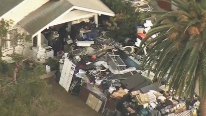 A house surrounded by garbage