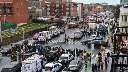 Emergency vehicles and the New York Police Department crowd the streets after at least 13 people were injured during a rush-hour shooting at a subway station in the New York borough of Brooklyn on April 12, where authorities said "several undetonated devices" were recovered amid chaotic scenes.
