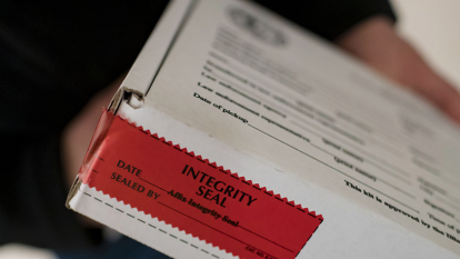 Image of Sexual Assault kit sealed by sticker reading "integrity seal."