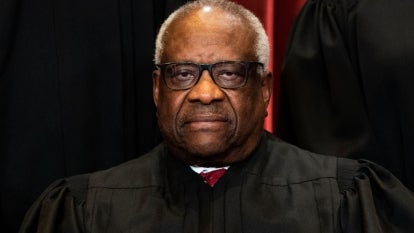 Associate Justice Clarence Thomas sits during a group photo of the Justices at the Supreme Court in Washington, DC.