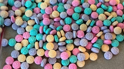 a bunch of blue, pink, purple and yellow pills