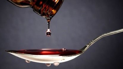 Pouring medication or antipyretic syrup into spoon