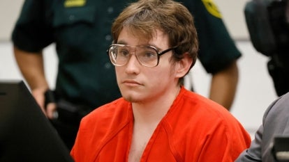 Nikolas Cruz in orange jumpsuit and round glasses