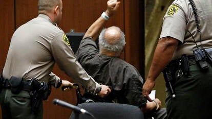 Samuel Little is being wheeled out of the courthouse following his 2014 conviction.