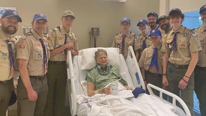 boy scouts standing around Eric Valentine's hospital bed