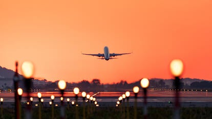 Airplane taking off at sunrise, travel and tourism