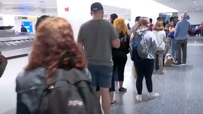 people waiting in line at Newark Airport