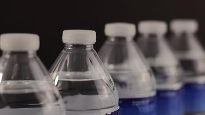Small water bottles placed in perspective view, and on a black background