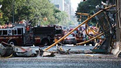 Debris from a crane collapse sit in the road as police, firefighters and emergency personnel gather at the scene in midtown Manhattan on July 26, 2023 in New York City