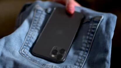 phone on top of a folded pair of jeans