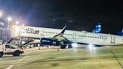 A JetBlue plane tilted backward after landing at JFK Airport.