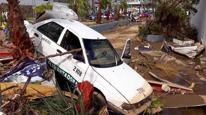 Car in ditch after Hurricane Otis.