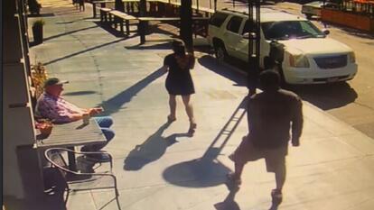 security footage of man approaching woman