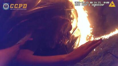 A Cobb County Police officer pulls a speeding driver out of a burning car.