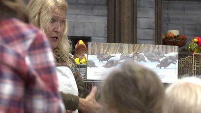 Woman teaches kids about turkeys.