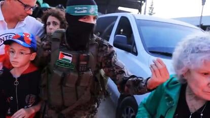 Member of Hamas with hostages.