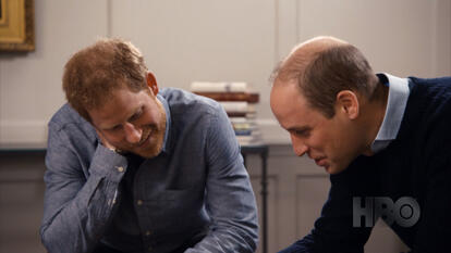 William and Harry looking at something out of shot