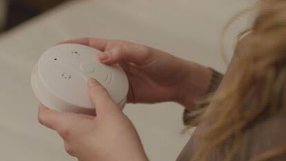 person holding a smoke detector