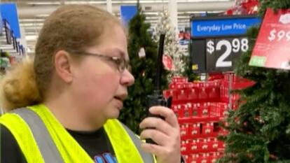 Gail Lewis in walmart holding walkie talkie
