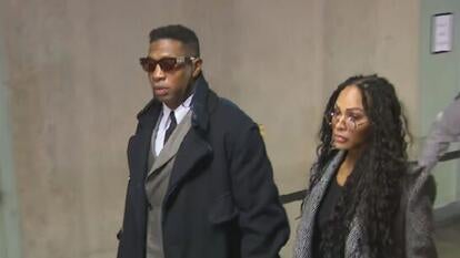 Jonathan Majors and Meagan Good walking in courthouse