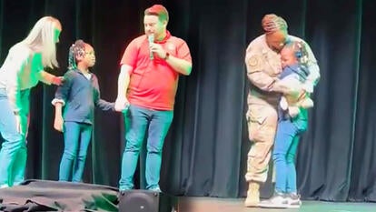 Little girl on Stage with teachers/ girl hugs mom