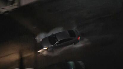 Car driving in dark.