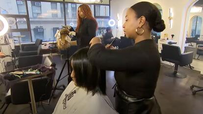 Hairstylist working on client