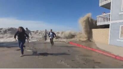 people running away from wave