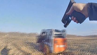 gun pointed at skid steer driver