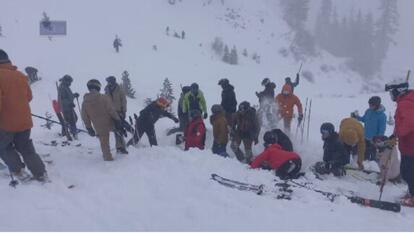 Skiers digging for skier buried under snow