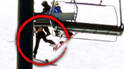 Snowboarder falling from ski lift