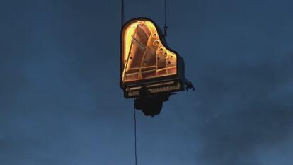 Pianist Alain Roche plays the piano suspended by a crane for his art installation entitled, “Piano Vertical.”