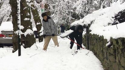 Two men shoveling snow