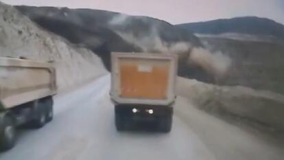 Trucks on road when landslide hits
