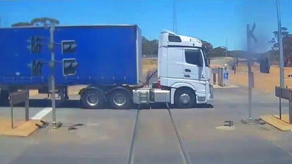 Train Narrowly Misses Hitting Big Wheeler Crossing the Tracks