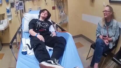 Nex Benedict in hospital bed with mother sitting close by