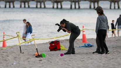 Investigators collect evidence from sand hole collapse.