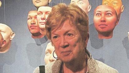 Jonna Mendez head and shoulders standing in front of assortment of masks