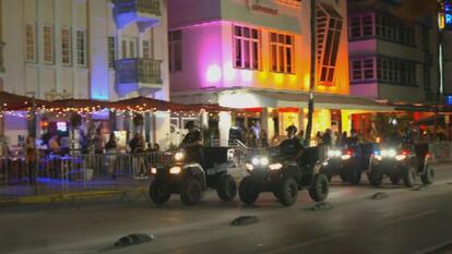 authorities riding down Miami street on ATVs