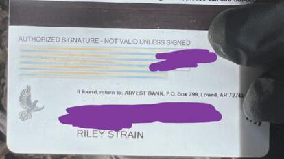 Back of bank card with Riley Strain's name