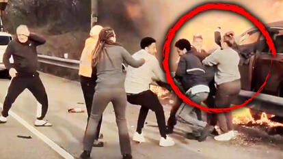 Driver being rescues from his burning SUV