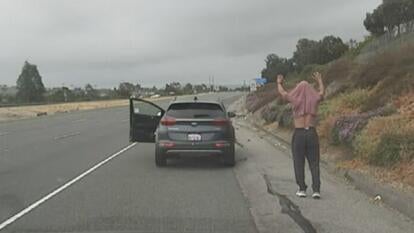 Jaime Rodgers walking backwards with his hands in the air and his shirt over his head