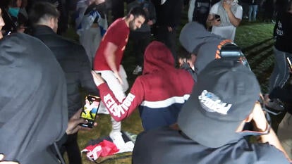 Israel supporters rip up and stomp on a Palestinian flag