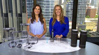 Megan Alexander and MorningSave representative stand behind table with products