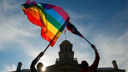 people holding Pride flags
