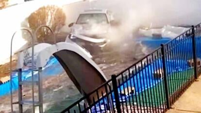 Crashed car smoking next to home pool