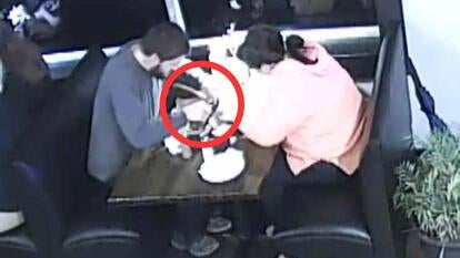 Man and woman sitting in a booth with a red circle