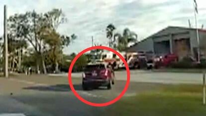 Red SUV driving into building