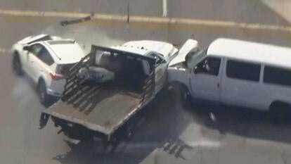 White truck crashing into a white SUV and a white van.